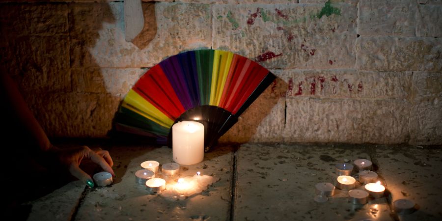 Members LGBT community light candles in solidarity with Florida's sho